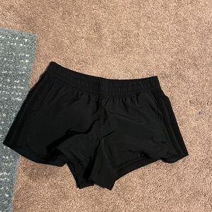 black adidas workout shorts with signature stripes